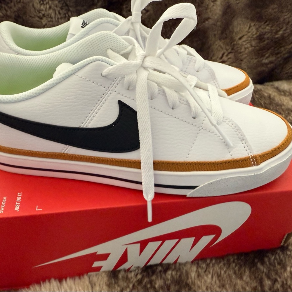 Nike White Sneakers with Black Swoosh and Gold Trim